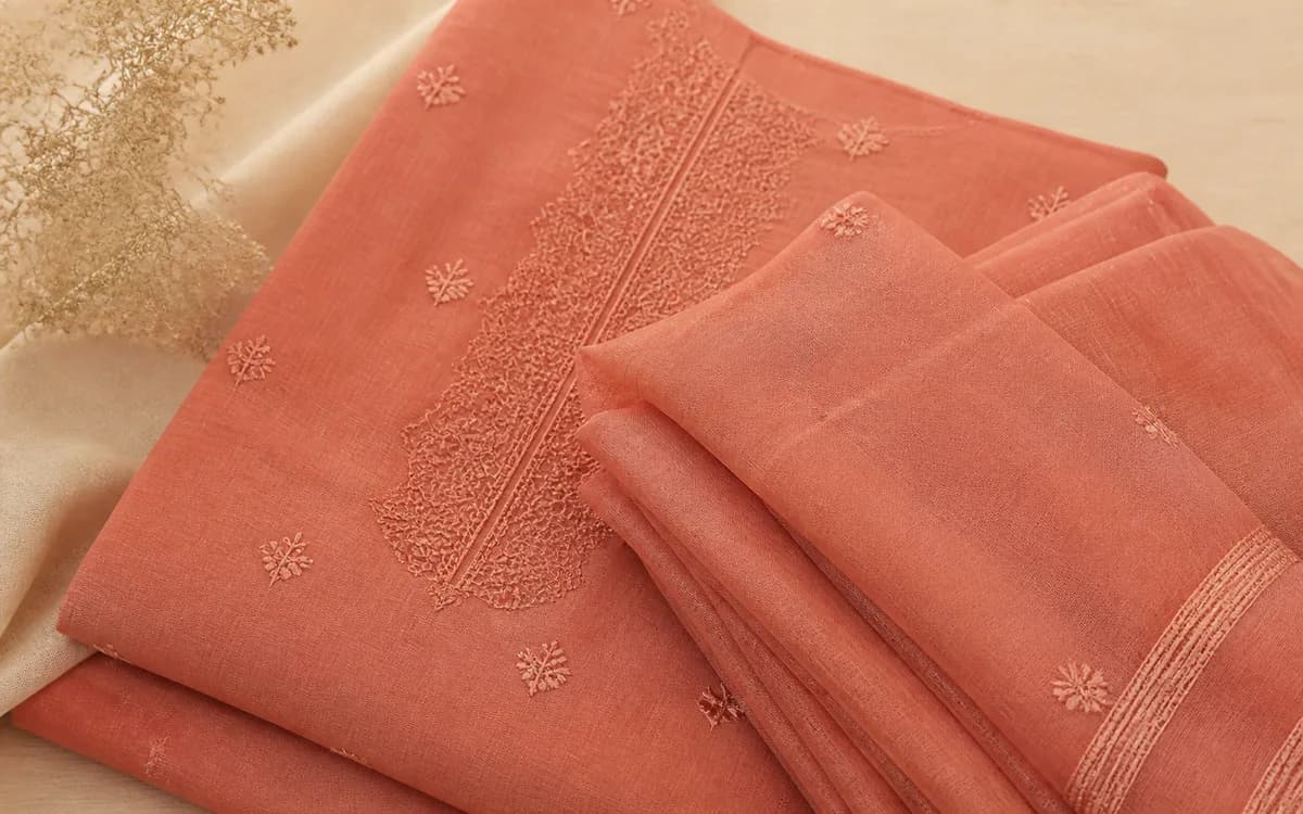 Editorial still life of a coral nightdress, representing nightwear & loungewear sourcing in Kolkata, West Bengal